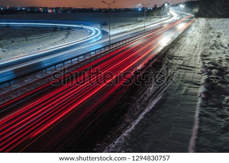 Fast moving traffic at night. winter season. concept of the road, snow and ice removal, danger and safety of movement, street lighting with energy-saving lamps