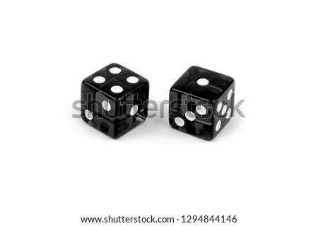Two black glass dice isolated on white background. Four and one.