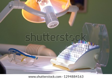 Professional Dentist tools in the dental office. Dental Hygiene and Health conceptual. Dental lamp is on