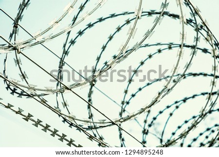 Barbed wire fence for protection. Entry ban. Cold photo filter.