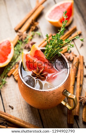 Grapefruit moscow mule in copper mug on the rustic background. Selective focus. Shallow depth of field.