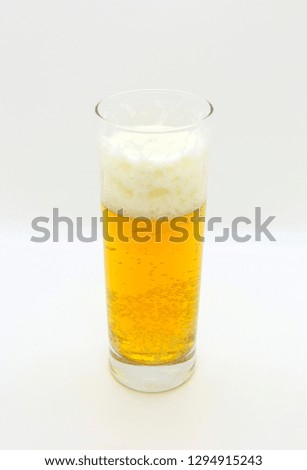 Glass of beer close up on a light background
