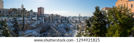 Panoramic View of the Gravina of the Town of Massafra, Covered by Snow on Blue Sky Background. Massafra, Italy