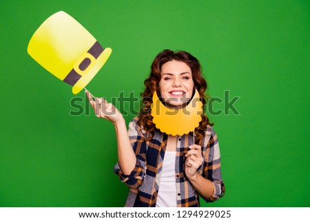 Close up photo of pretty with fake paper hat and beard on stick she her lady say hi to all party members taking yellow cap up wearing casual checkered plaid shirt isolated on green bright background