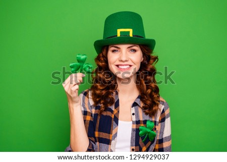 Close up photo of she her brunette hold hand showing leaf as symbol of holiday tradition wearing casual checkered plaid shirt leprechaun headwear isolated green vivid bright vibrant background