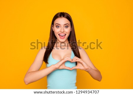 Studio photo portrait of pretty cute tender gentle nice beautiful attractive charming she her girl make give heart on chest isolated bright vivid background