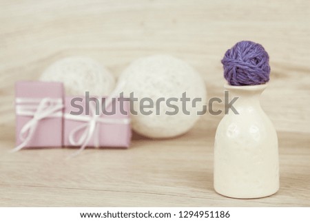 Balls of yarn for knitting on a light wooden background. Decorations for Valentine's Day and Mother's Day. Romantic atmosphere.