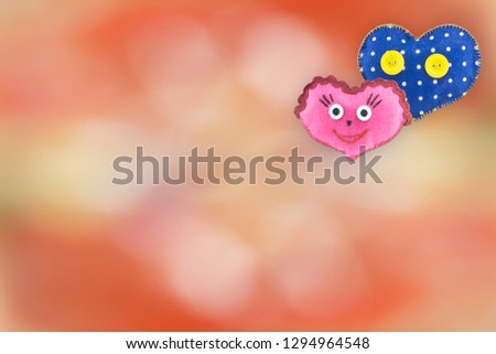 Handmade toys in the form of a heart for Valentine's Day on a bright background.Two lovers' hearts