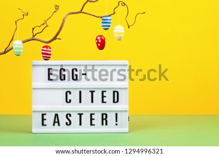 Light box over the bright pastel background with the text. Easter celebration concept