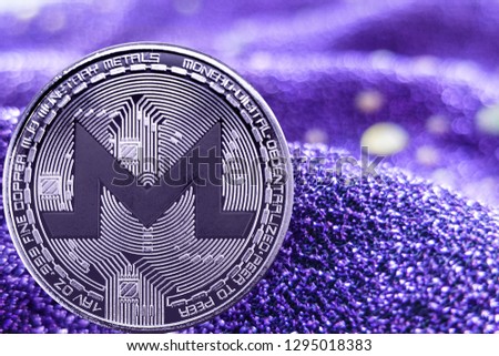 Coin cryptocurrency Monero and neon fabric background. XMR