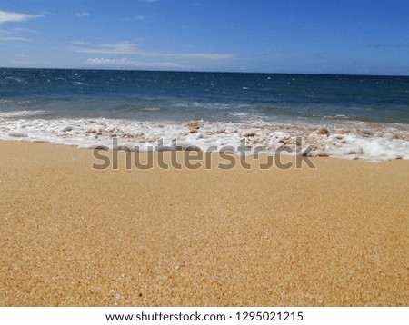 Waves break on a white sand beach