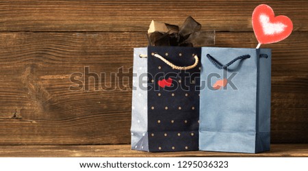 Blue gift bags with hearts on wooden background. celebration. St. Valentine's Day. March 8. mothers Day. birthday.