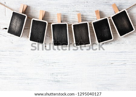 hanging wooden signs on clothespins on a white background