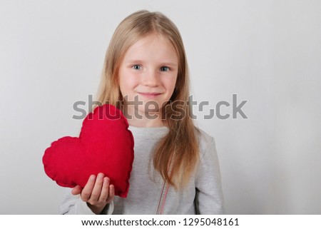 Cute little girl holding a red heart symbol of love and romance , Valentines, Mothers day