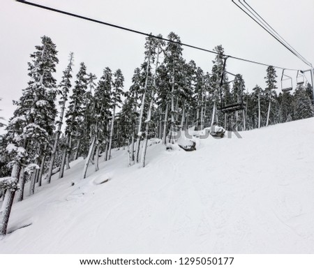 an empty ski lift going down the mountain