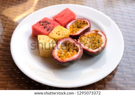 Passion fruit, watermelon, pineapple. Passion fruits are round or oval. They can be yellow, red, purple, and green. The fruits have a juicy edible center composed of a large number of seeds.