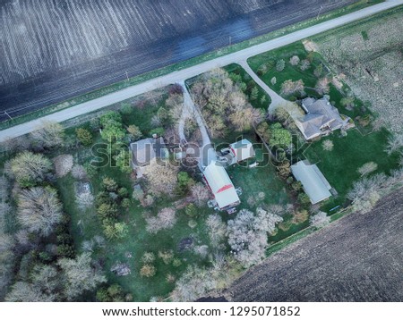 Aerial HDR Landscape featuring farm and empty fields with barn in rural Iowa