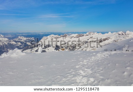 View from Mt. Titlis in Switzerland in winter. The Titlis is a mountain, located on the border between the Swiss cantons of Obwalden and Bern, it is usually accessed from the town of Engelberg.