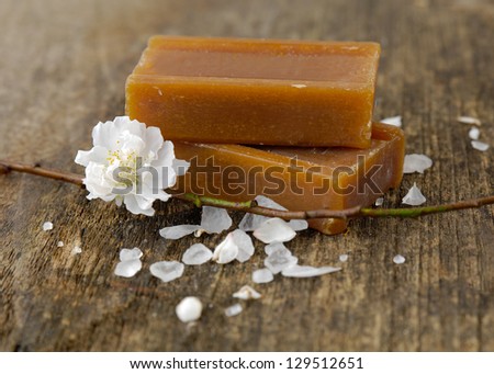 bunch of spring flower with soap on old wooden