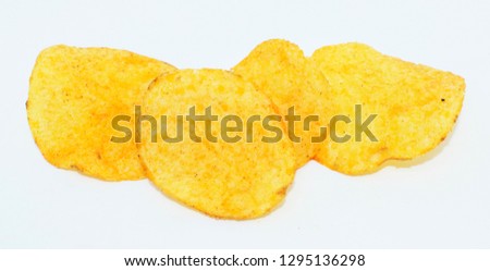 Yellow potatoes chips on background - popular snack