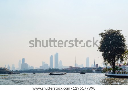 The picture of Chaophraya river scenery with city building for background from the boat. Bangkok, Thailand.