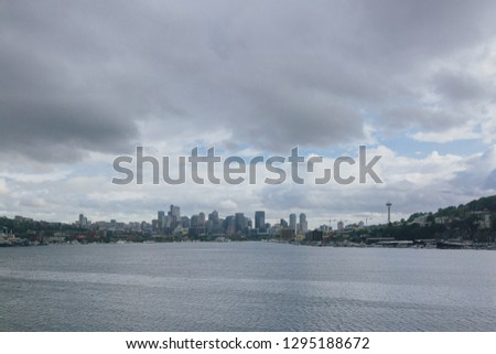 View of skyline of downtown Seattle over Lake Union under clouds, in Seattle, USA