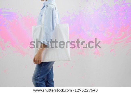woman holding eco fabric bag isolate on gray background