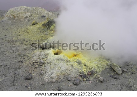 View on fumarole in crater of Mutnovsky volcano. It's an opening in a planet's crust, which emits steam and gases such as carbon dioxide, sulfur dioxide, hydrogen chloride, and hydrogen sulfide.