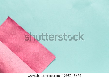 pink paper roll isolated on syan paper background