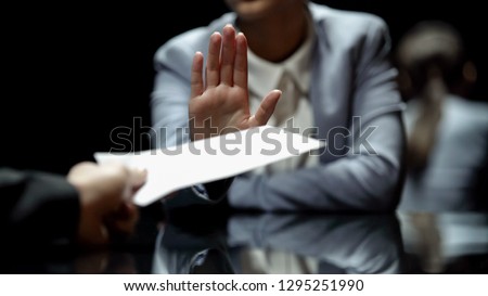 Female official refuses to take bribe, anti-corruption laws in action, close up Royalty-Free Stock Photo #1295251990