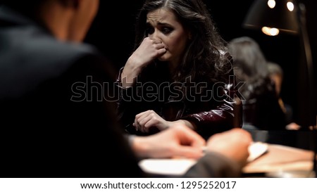 Female criminal crying regretfully, giving open-hearted confession about crime Royalty-Free Stock Photo #1295252017