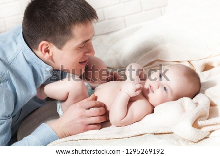 baby with dad. family, parenthood and people concept - father with little baby at home
