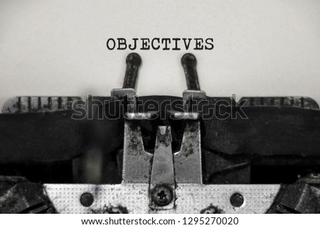 Objectives word with black and white typewriter concept