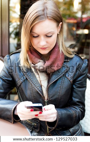 young woman which read by phone on white background