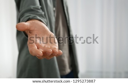 Man giving hand to somebody, closeup. Help and support concept Royalty-Free Stock Photo #1295273887
