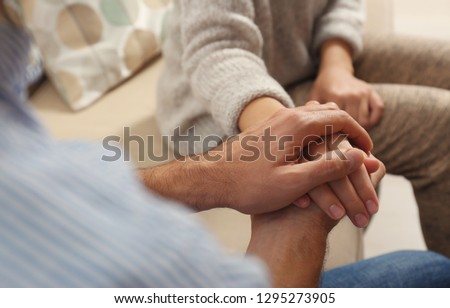 Man comforting woman, closeup of hands. Help and support concept Royalty-Free Stock Photo #1295273905