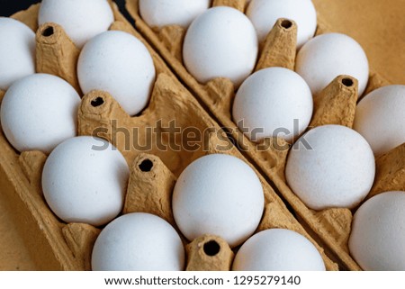 Organic white chicken eggs for food in carton box.