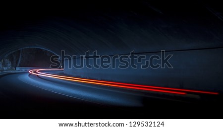 Car light trails in the tunnel. Art image . Long exposure photo taken in a tunnel