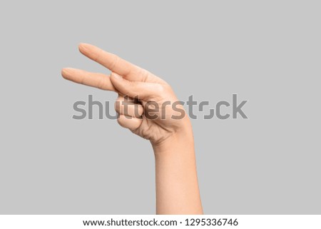 Woman showing P letter on grey background, closeup. Sign language