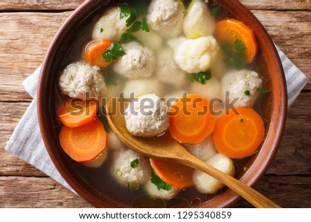 Delicious Danish soup with meat balls, dumplings and vegetables close-up in a bowl. horizontal top view above
