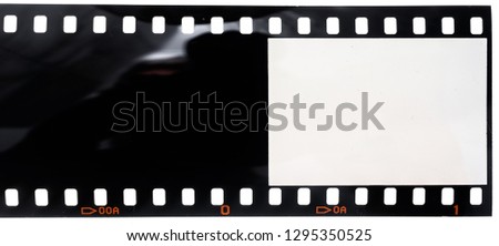 long 35mm film strip or negative on white, first blank and empty frame of the role, place your photo content here, dia positive material Royalty-Free Stock Photo #1295350525