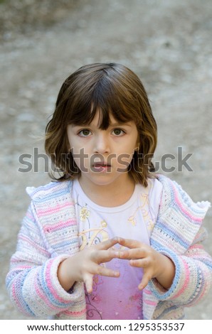Serious little girl outdoors