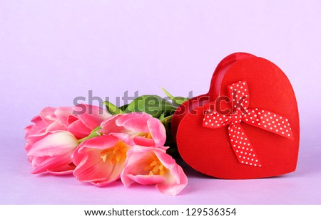 Pink tulips and gift box, on color background