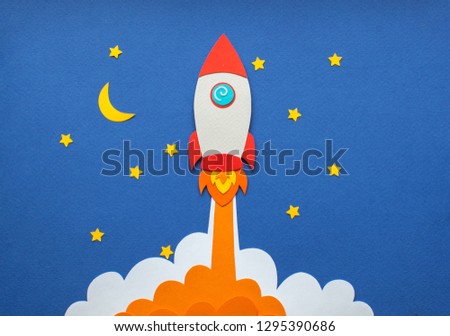 The launch into space. Flying rocket through the clouds. Start up of the space rocket. Rocket ship in flat design on blue background. 3d paper r. Concept of business launch. Paper cut.