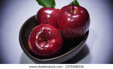 Fresh apple with stem leaf on bowl. Image fruit