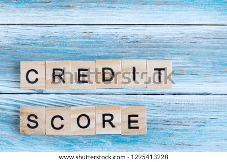 Black letters on wooden cubes lined inscription credit score. Wooden background. Credit history. Concept. Family and person finance. Bank.