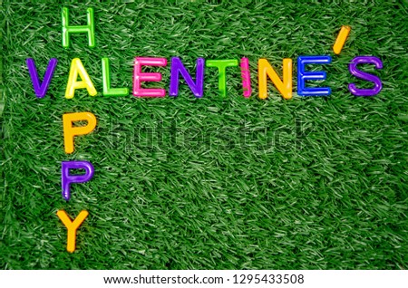 colorful valentine's font on grass background with copy space,alphabet Valentine Day on green screen, texture of background,in lovely festival,for put your photo in empty space to card or web media 