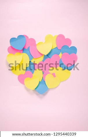 paper colorful heart shape arrange in big heart on background,post pad on board,love and valentine's day symbol,picture shape collage