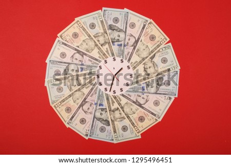 Concept of clock and dollar. Clock on mandala kaleidoscope from money. Abstract money background raster pattern repeat mandala circle. On red background.