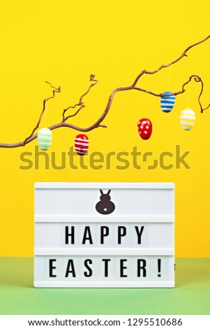 Light box over the pastel background with the text Happy Easter. Easter celebration concept